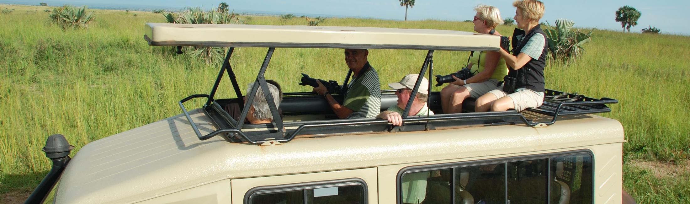 Tourist in safari vehicle with open roof and large windows